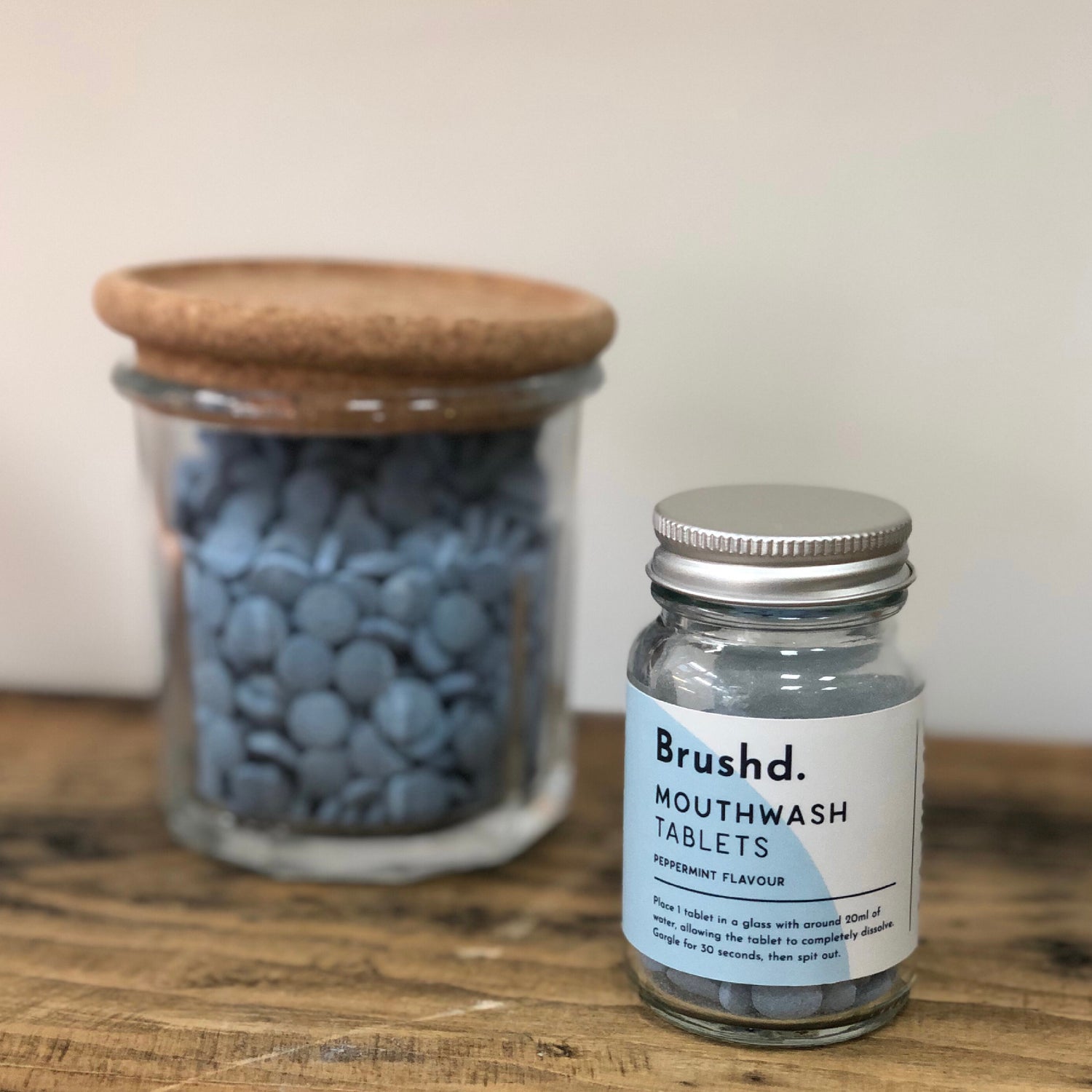 front view of mouthwash tablets in glass jar with refill option behind on display in weigh and pay shop