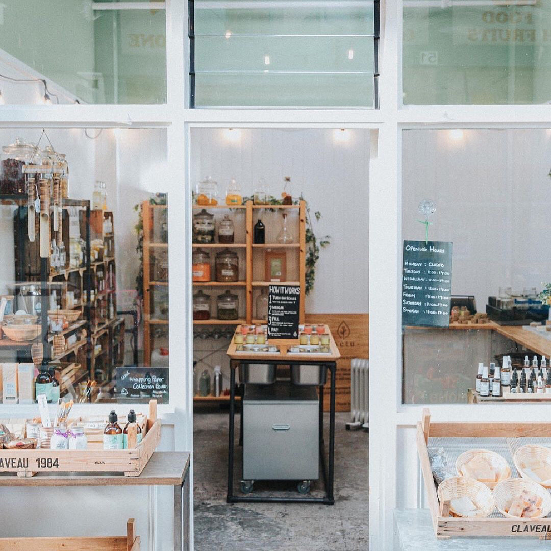 shopfront of Weigh and Pay, a zero waste shop in Brixton Village Indoor Market, image of colourful shopfront independent london