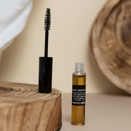 black castor oil serum for eyelashes lashes brows mascara tube by suneeta London x weigh and pay