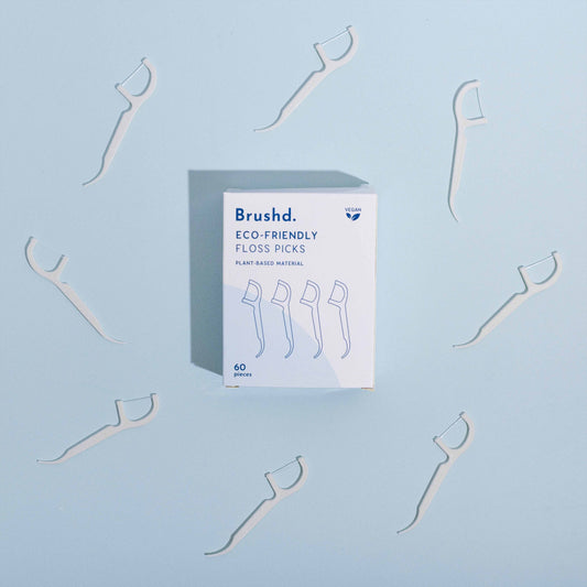 brushd eco friendly floss picks, blue background, birds eye view