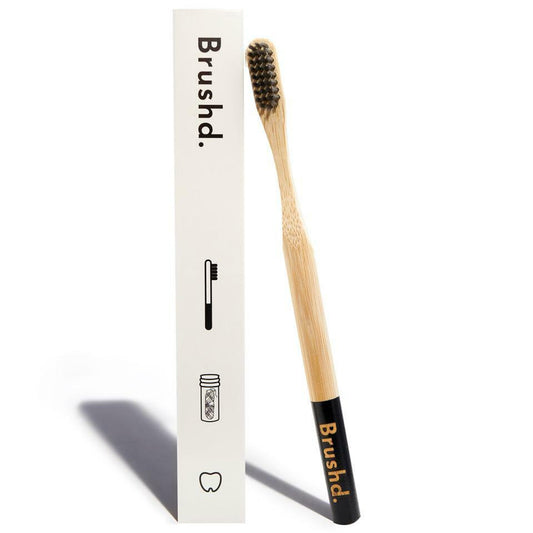brushd bamboo toothbrush, black handle, charcoal bristles, white background