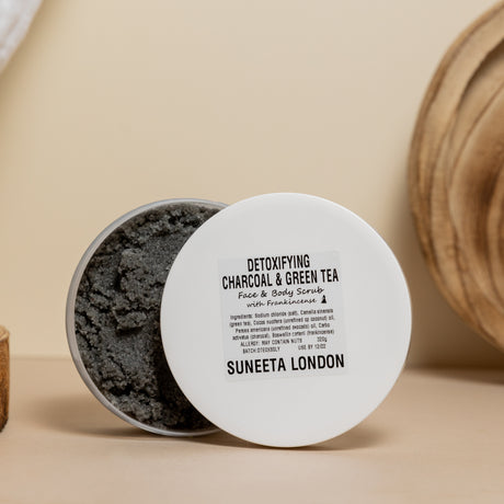 suneeta london's detoxifying charcoal and green tea face and body scrub. 320g pot