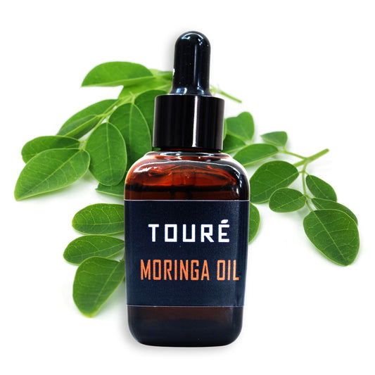 touré cold pressed moringa oil with leaf on white background