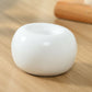 white ceramic toothbrush holder, brushd